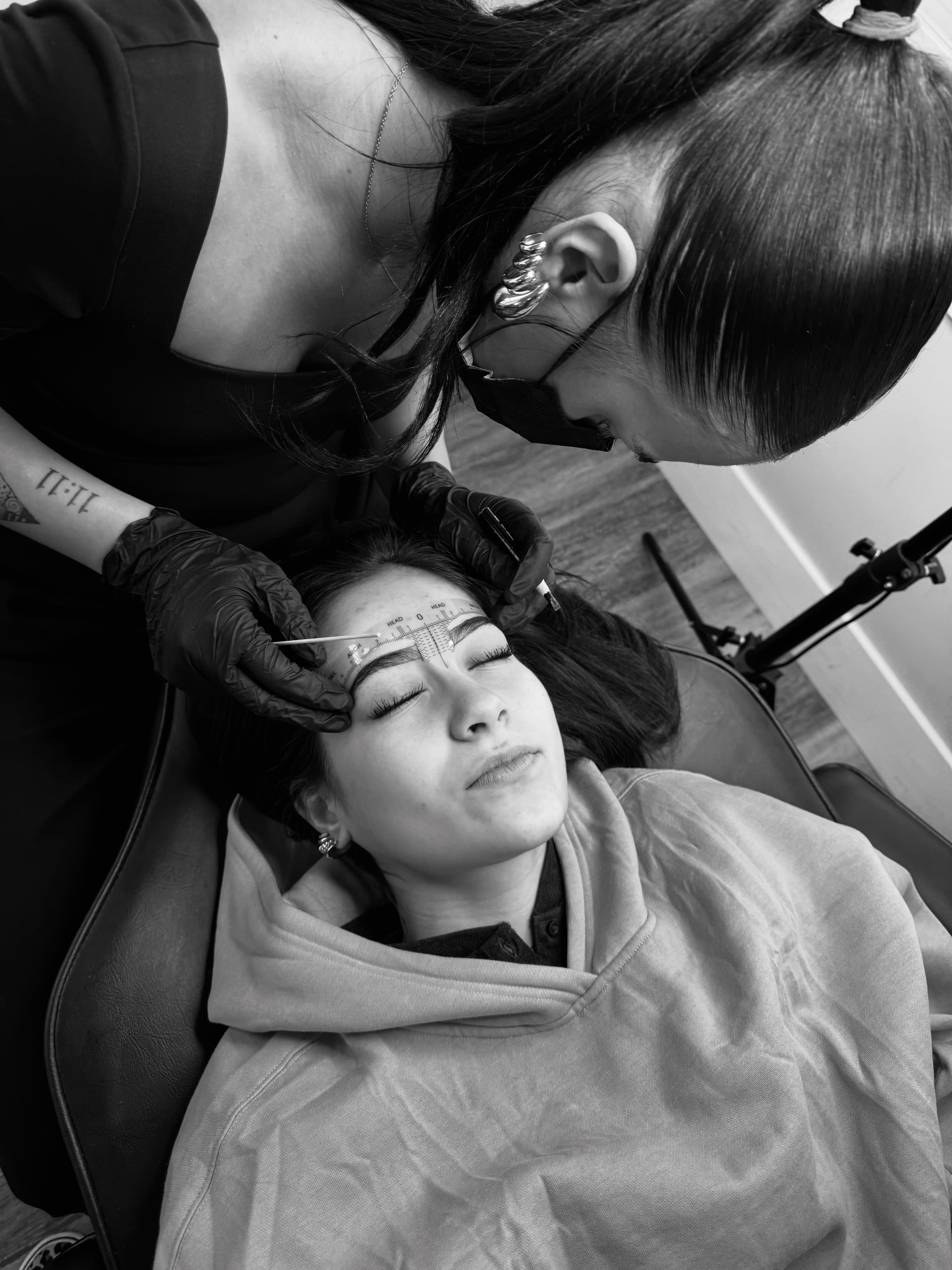 Emma Hornberger working on permanent makeup